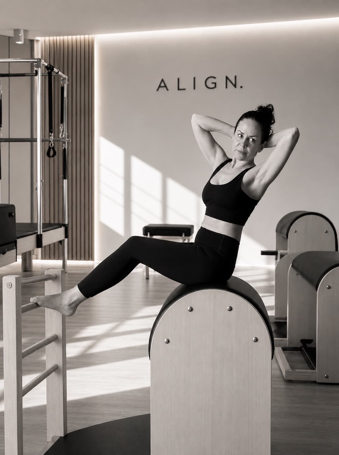 Vesna Daniel, certified Classical Pilates teacher, performing a barrel exercise at ALIGN Studio Stuttgart